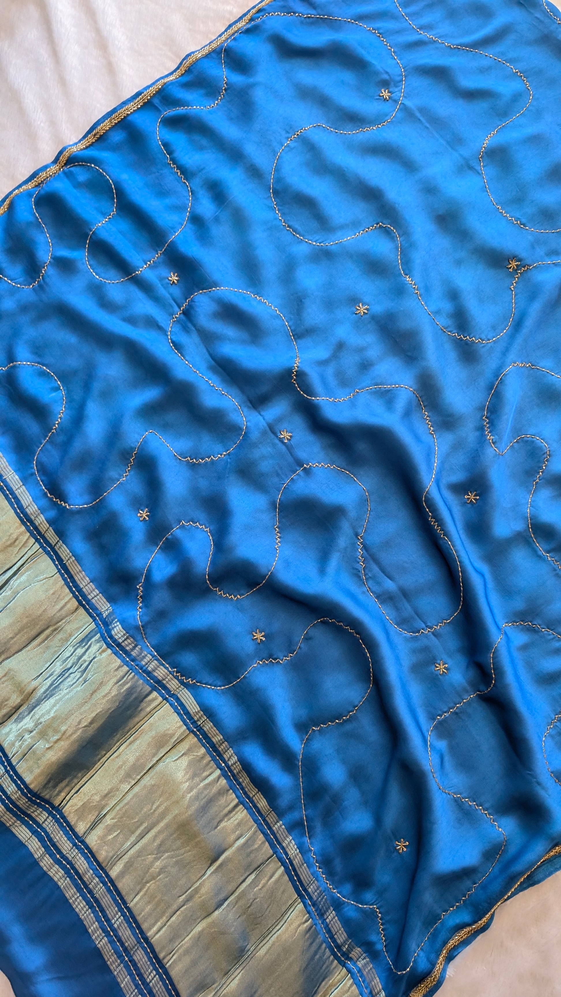 Blue modal silk saree with embroidered patterns